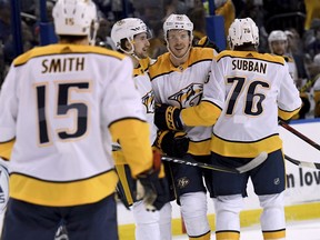 Nashville Predators right wing Craig Smith (15), left wing Filip Forsberg (9), center Ryan Johansen (92) and defenseman P.K. Subban (76) celebrate Johansen's first period goal during an NHL hockey game against the Tampa Bay Lightning Sunday, April 1, 2018, in Tampa, Fla.