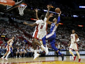 Philadelphia 76ers guard Ben Simmons (25) shoots in the first quarter as Miami Heat forward James Johnson (16) defends in Game 4 of a first-round NBA basketball playoff series, Saturday, April 21, 2018, in Miami.