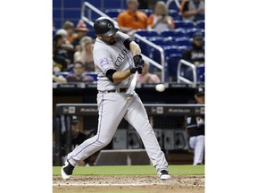 Colorado Rockies' Antonio Senzatela hits a double scoring Gerardo Parra during the fifth inning of a baseball game against the Miami Marlins, Friday, April 27, 2018, in Miami.