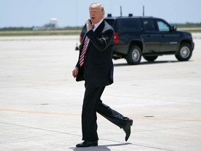 President Donald Trump walks across the tarmac to greet members of the military and their families upon his arrival at Naval Air Station Key West on Air Force One in Key West, Fla., Thursday, April 19, 2018.