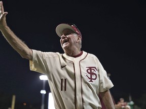 Florida State head coach Mike Martin waves to the crowd while celebrating career win 1,975 after his team defeated Miami in an NCAA college baseball game in Tallahassee, Fla., Saturday, April 28, 2018.