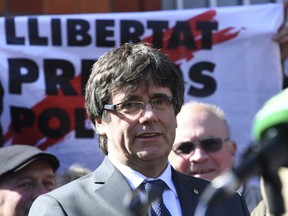 Former Catalan leader Carles Puigdemont gives a press statement after he was released on bail from the prison in Neumuenster, northern Germany, Friday, April 6, 2018.