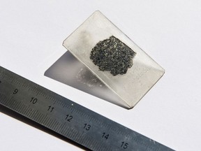 Photo provided by Hillary Sanctuary of EPFL shows a thin slice of the meteorite sample from a meteorite that fell to Earth more than a decade ago providing compelling evidence of a lost planet that once roamed our solar system, according to a study published Tuesday.