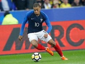 In this photo taken on Friday March 23, 2018, France's Kylian Mbappe controls the ball during a friendly soccer match between France and Colombia in Saint-Denis, outside Paris.