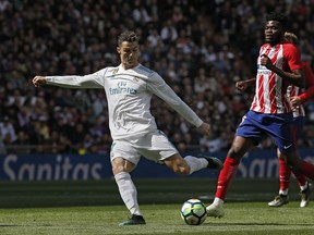 Real Madrid's Cristiano Ronaldo shoots the ball during the Spanish La Liga soccer match between Real Madrid and Atletico Madrid at the Santiago Bernabeu stadium in Madrid, Sunday, April 8, 2018.
