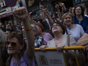 Women shout slogans during a protest outside the Justice Ministry in Madrid, Thursday, April 26, 2018. Women's rights groups are protesting after a northern Spanish court sentenced five men to nine years in prison for the lesser crime of sexual abuse in what they see as a gang rape case during the running of the bulls festival in Pamplona two years ago.