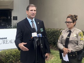 Los Angeles County sheriff's Lt. John Corina, left, speaks next to Deputy Joana Warren outside of the sheriff's homicide bureau office in Monterey Park, Calif., Thursday, April 19, 2018. Los Angeles County sheriff's investigators say a 16-year-old was arrested on suspicion of murder after his teenage friend was found stabbed to death.