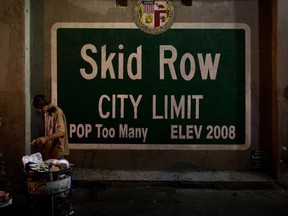 FILE - In this Oct. 28, 2017 file photo, a homeless man takes food from a trash can in Los Angeles' Skid Row area, home to the nation's largest concentration of homeless people in Los Angeles. California is doing a poor job of sheltering the nation's largest homeless population and needs to provide statewide leadership to address the problem, the state auditor said Thursday, April 19, 2018, in a report that also singled out problems with homeless services in Los Angeles County.