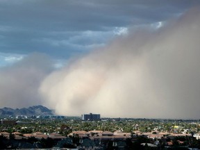 FILE - In this July 21, 2012 file photo a large dust storm, or haboob, sweeps across downtown Phoenix. Drought is stiffening its hold across the American Southwest as extreme conditions spread from Oklahoma to Utah. The federal drought map released Thursday, April 12, 2018, shows dry conditions especially intensified across northern New Mexico and expanded in Arizona.