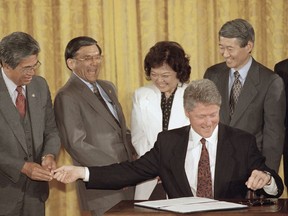 File - In this May 3, 1993 file photo, President Bill Clinton reaches for a pen as he hands another pen used in signing the Asian/Pacific American Heritage Awareness Proclamation to Sen. Daniel Akaka (D-HI), during the signing ceremony at the White House, Washington, May 3, 1993. Looking on are, from left, Rep. Norman Mineta (D-Calif.), Rep. Patsy Mink (D-HI), and Rep. Robert Matsui (D-California). Former U.S. Sen. Daniel Akaka, the humble and gracious statesman who served in Washington with aloha for more than three and a half decades, died Thursday , April 5, 2018, at the age of 93, sources tell the Star-Advertiser. He had been hospitalized with an illness.