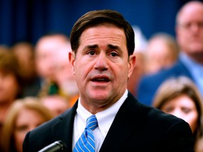 FILE - In this Jan. 22, 2018, file photo, Arizona Gov. Doug Ducey speaks prior to signing the order calling the Legislature into a special session at the Capitol in Phoenix. Arizona Gov. Ducey is pushing lawmakers to approve his proposal for big teacher raises Monday, April 23, 2018, as school districts make plans to shut down if educators statewide walk off the job as planned this week after calling the Republican governor's plan insufficient.