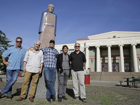 In this Friday, April 13, 2018, photo, the Waldos, from left, Mark Gravitch, Larry Schwartz, Dave Reddix, Steve Capper and Jeffrey Noel pose below a statue of Louis Pasteur at San Rafael High School in San Rafael, Calif. Friday is April 20, or 4/20. That's the numerical code for marijuana's high holiday, a celebration and homage to pot's enduring and universal slang for smoking. And the five Northern California high school stoner buddies widely credited with creating the shorthand slang for getting high nearly 50 years ago now serve as the day's unofficial grand masters.