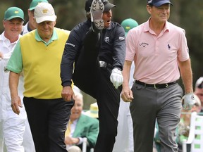 Six-time Masters champion Jack Nicklaus, left, three-time Masters champion Gary Player starting with a kick, and two-time Masters champion Tom Watson leave the first tee  during the Par-3 Contest at the Masters golf tournament at Augusta National Golf Club in Augusta, Ga., Wednesday, April 4, 2018.