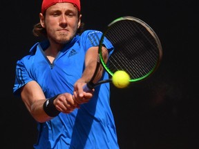 France's Lucas Pouille returns the ball against Italy's Andreas Seppi during their Davis Cup World Group quarterfinal match in Genoa, Italy, Friday, April 6, 2018.