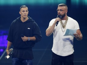 In this April 12, 2018 photo German rappers Kollegah and Farid Bang receive the "Hip-Hop/Urban national" award during the 2018 Echo Music Awards ceremony in Berlin.