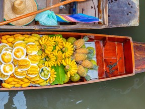 Long-tail boat with fruits on the floating market, Damnoen Saduak floating market in Ratchaburi near Bangkok, Thailand