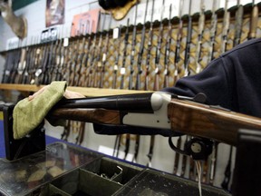 An Ottawa hunting store salesperson wipes a shotgun on Tuesday, May 16, 2006. Gun control could wind up being a defining issue in next year's federal election. Eighteen months ahead of the vote, both the governing party and the official Opposition are laying the groundwork for making guns a wedge issue, to carve away a share of each other's softer support.