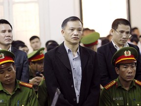 Prominent human rights lawyer Nguyen Van Dai, center, stands trial in Hanoi, Vietnam, Thursday, April 5, 2018. Dai and five others were accused of attempting to overthrow the government as the communist authority steps up its crackdown on dissent.