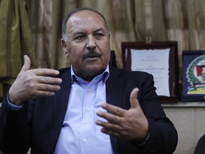 In this picture taken on Tuesday, April 17, 2018, Khaled Abdul-Majid, a leader of Palestinian Resistance Factions Coalition speaks during an interview with The Associated Press in Damascus, Syria. Syrian troops and pro-government Palestinian gunmen have been sending reinforcements and fortifying their positions around a refugee camp held by the Islamic State group south of the capital Damascus in preparations for an all-out offensive against the extremists if negotiations for their departure from the area fails.