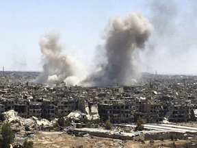 Smoke rises after Syrian government airstrikes and shelling hit in Hajar al-Aswad neighborhood held by Islamic State militants, southern Damascus, Syria, Tuesday, April 24, 2018. Syrian state TV is reporting that government forces have launched a new operation targeting underground tunnels used by the Islamic State group in the capital, Damascus. (AP Photo)