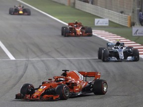 Ferrari driver Sebastian Vettel of Germany leads at the start and followed by Mercedes driver Valtteri Bottas of Finland and Ferrari driver Kimi Raikkonen of Finland during the Bahrain Formula One Grand Prix, at the Formula One Bahrain International Circuit in Sakhir, Bahrain, Sunday, April 8, 2018.