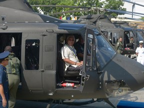 Philippine defence secretary Voltaire Gazmin poses in the cockpit of a newly-delivered Bell 412 helicopter during a christening ceremony in Manila on August 17, 2015.