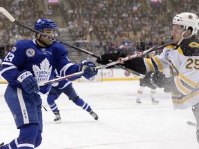 Toronto Maple Leafs centre Nazem Kadri (left) and Boston Bruins defenceman Brandon Carlo  high-stick each other on Nov. 10, 2017. Only Carlo was penalized on the play.