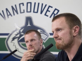 Vancouver Canucks forwards Henrik, right, and Daniel Sedin announce their retirements from hockey at Rogers Arena in Vancouver on April 2.