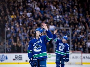 Daniel and Henrik Sedin salute the crowd at Rogers Arena in Vancouver on April 5.
