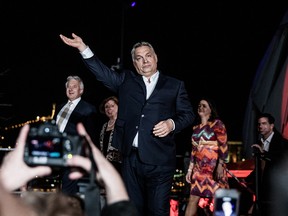 Viktor Orban, Hungary's prime minister, waves to supporters as he arrives at the Fidesz party headquarters following results for the parliamentary elections in Budapest, Hungary, on Monday, April 9, 2018.