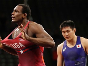 United States' J'den Cox, left, celebrates after defeating Japan's Takashi Ishiguro, right, in their 92 kg match in the Freestyle Wrestling World Cup, Saturday, April 7, 2018, in Iowa City, Iowa.