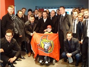 In this March 29, 2017 file photo, the Ottawa Senators visit with Jonathan Pitre during a trip to Minneapolis.
