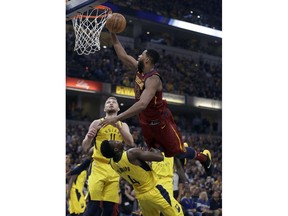 Cleveland Cavaliers' Tristan Thompson (13) heads to the basket as Indiana Pacers' Domantas Sabonis (11) and Victor Oladipo (4) defend during the first half of Game 4 of a first-round NBA basketball playoff series, Sunday, April 22, 2018, in Indianapolis.