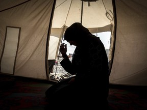 This photo released by Amnesty International on Tuesday, April 17, 2018 shows 33-year-old mother of six, Zahra, inside her tent in Salamiya camp for internally displaced people where she and her family have lived for seven months. Originally from Shwra, south of Mosul, the family moved to Mosul three years ago after Zahra's husband joined ISIL, working with the group as a cook. He was killed by an airstrike in June 2017. Amnesty says its report details the predicament of thousands of female-led families left to fend for themselves in displaced camps after male family members were killed, arbitrarily arrested or forcibly disappeared.