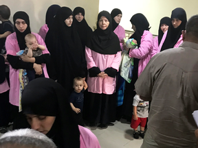 Russian women who were sentenced to life in prison for joining the Islamic State 
wait at Baghdad’s Central Criminal Court with their children.