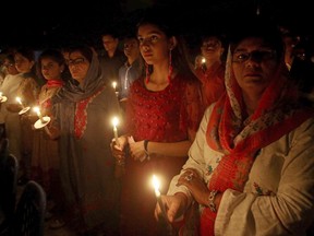 Pakistani Christians hold candles while attending midnight Easter service at St. Patrick church in Karachi, Pakistan, Saturday, March 31, 2018. Christians across the world are celebrating Easter, commemorating the day followers believe Jesus was resurrected in Jerusalem 2,000 years ago.