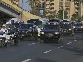 Pakistani security personnel escort minibuses carrying the West Indies and Pakistani cricket teams to the National stadium for the first T20 international match in Karachi, Pakistan, Sunday, April 1, 2018. The West Indies cricket team arrived in Karachi to play three T20 matches against Pakistan.
