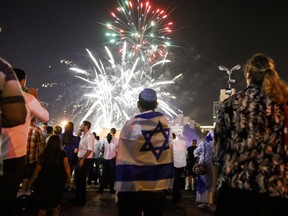 Israeli youths watch fireworks over Jerusalem late on April 18, 2018, at conclusion of Memorial Day and the start of the 70th Independence Day celebrations.