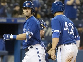 Toronto Blue Jays' Randal Grichuk, left, crosses home plate with Aledmys Diaz after hitting a three-run home run against the Kansas City Royals at the Rogers Centre on Tuesday April 17, 2018. (THE CANADIAN PRESS/Fred Thornhill)