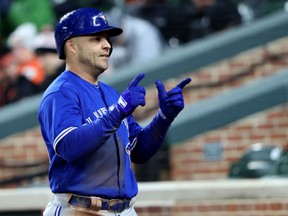 Steve Pearce of the Toronto Blue Jays acknowledges the cheers from the dugout after hitting a third-inning homer in Monday's 7-1 victory over the Baltimore Orioles at Camden Yards in Baltimore.