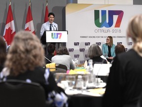 Oxfam Canada executive director Julie Delahanty and delegates looks on as Prime Minister Justin Trudeau delivers remarks at the W7: Feminist Visions for the G7 meeting in Ottawa on Wednesday, April 25, 2018.