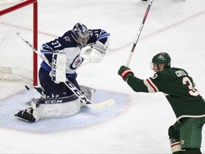 Minnesota Wild centre Charlie Coyle (right) celebrates a goal against the Winnipeg Jets on April 15.