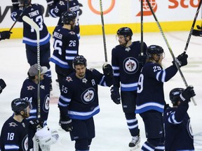 Members of the Winnipeg Jets salute the fans following their 5-0 win over the Minnesota Wild Friday in Game 5 of their Western Confernce quarter-final. By virtue of the win, the Jets won the series 4-1.