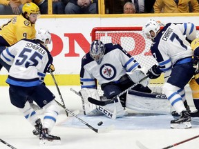 Winnipeg Jets' goaltender Connor Hellebuyck denies Filip Forsberg, left, of the Nashville Predators from close in during Game 1 action in their West Conference semifinal Friday in Nashville. Hellebuyck had 47 saves as the Jets posted a 4-1 victory.