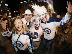 Winnipeg Jet fans celebrate at Portage an Main in downtown Winnipeg after the Winnipeg Jets defeated the Minnesota Wild in game five NHL playoff action to win the first round 4-1 in Winnipeg on Friday, April 20, 2018.