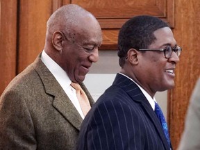 Actor and comedian Bill Cosby, left, is escorted by his spokesperson publicist Andrew Wyatt, during his sexual assault retrial  at the Montgomery County Courthouse in Norristown, Pa., Monday, April 23, 2018.