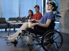 Humboldt Broncos hockey player Ryan Straschnitzki, who was paralyzed following a bus crash that killed 16 people, speaks to the media as his father Tom, centre, and as his mother Michelle, look on in Calgary, Alta., Wednesday, April 25, 2018.THE CANADIAN PRESS/Jeff McIntosh