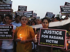 Lawyers participate in a candle light procession in protest against the rape and murder of an 8-year-old girl, in Jammu, India, Saturday, April 14, 2018. The girl was grazing her family's ponies in the forests of the Himalayan foothills when she was kidnapped and her mutilated body found in the woods a week later. Thousands of members of a radical Hindu group with links to the ruling party have marched to demand the release of six men accused in the repeated rape and murder of the Muslim girl inside a Hindu temple.