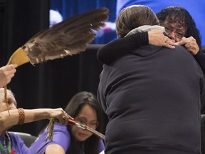 Trudy Smith, right, receives a hug following her testimony about her murdered sister Pauline Johnson during the National Inquiry of Missing and Murdered Indigenous Women and Girls in Richmond, B.C., Friday, April, 6, 2018.