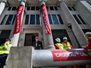 Protesters use a mock oil pipeline to block the entrance to the Canadian Embassy in London on April 18, 2018, as they protest against the Trans Mountain oil pipeline.